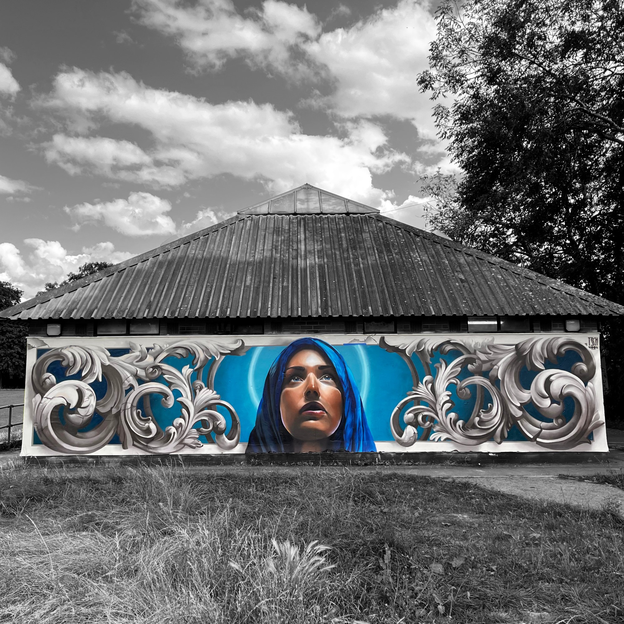 street art mural of a madonna and ornamental framework by Tech Moon