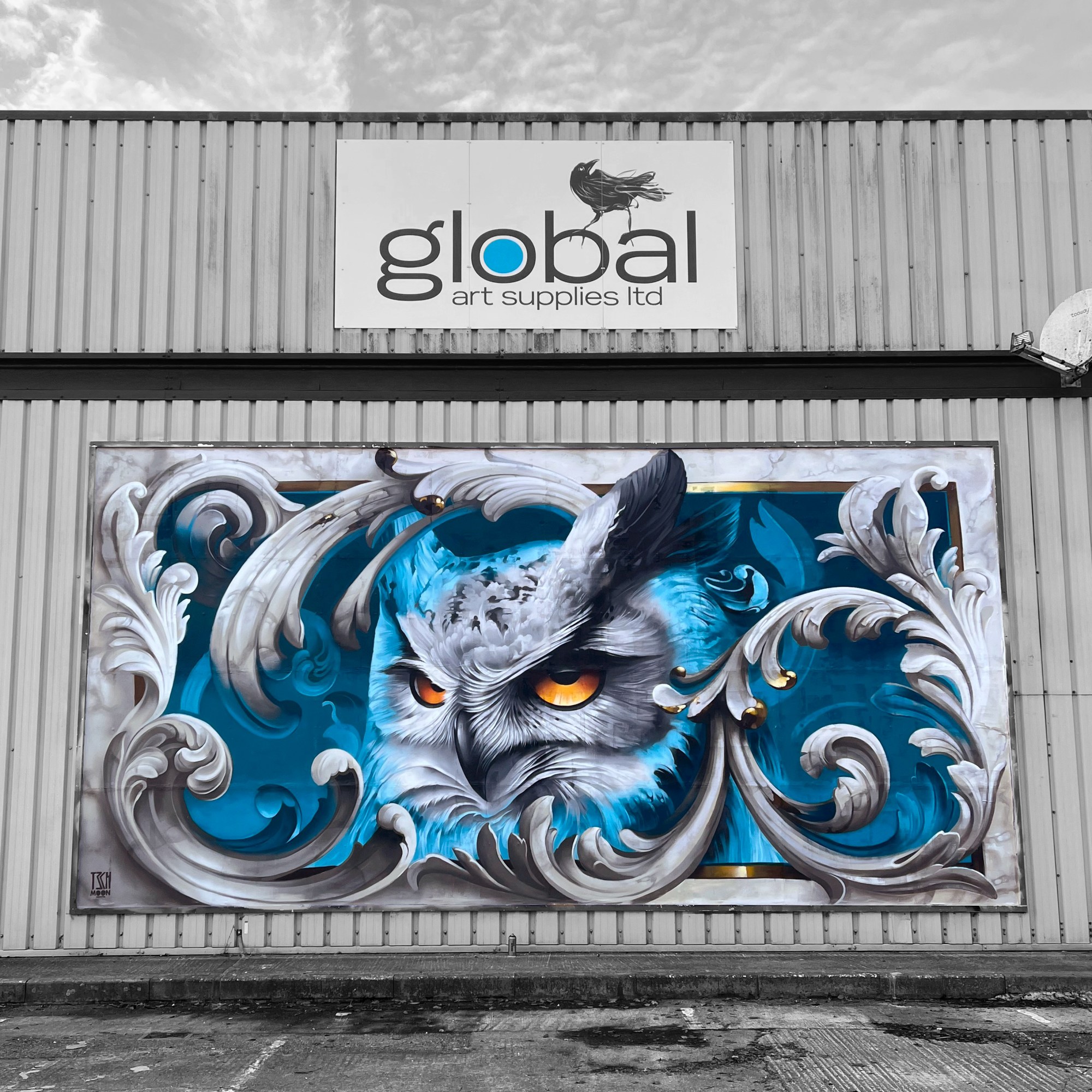 street art mural of an owl with an ornamental stone frame. Painted for Montana Cans in Salisbury by Tech Moon